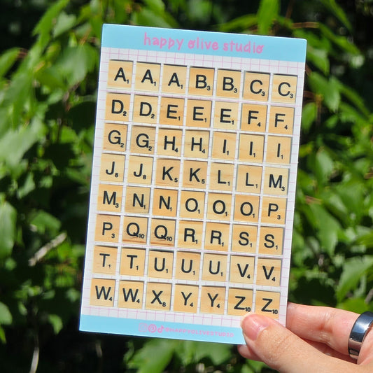 a sticker sheet of alphabet letters in the shape of board game tiles