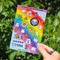 sticker sheet that features ghosts reading books and eating pizza. there are pizza slices, books, stars, and quotes that say 'i love books' and 'will read for pizza' and a badge that says BOOOK IT. Also pizza box that says pizza haunt. All against a rainbow background