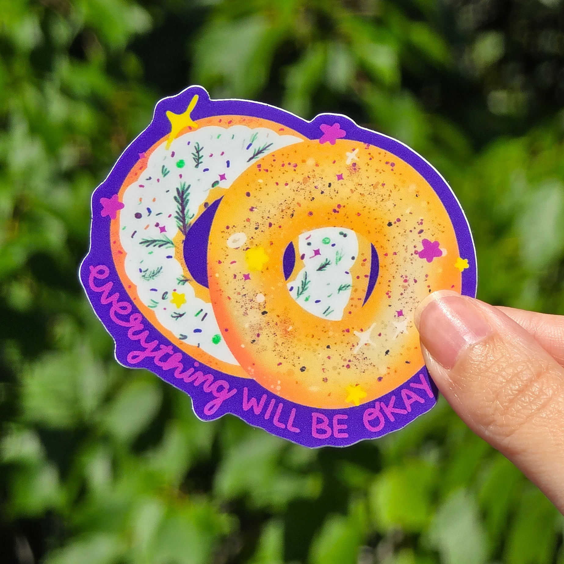 image of an everything bagel cut in half, says everything will be okay