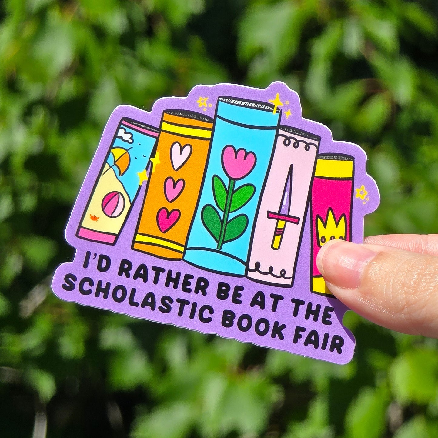 I'd Rather Be at the Scholastic Book Fair sticker features 4 books against a purple background