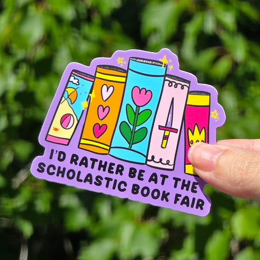 I'd Rather Be at the Scholastic Book Fair sticker features 4 books against a purple background