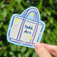 sticker of a tote bag that says salt air. it is a white bag with pink trim and handles