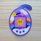 oval shaped 'digital pet' sticker. the pet in the center is a smiling star. the border of the sticker is clouds, stars, and rainbows. 