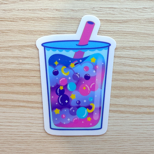 Colorful drink with bubbles and a straw on a wooden surface