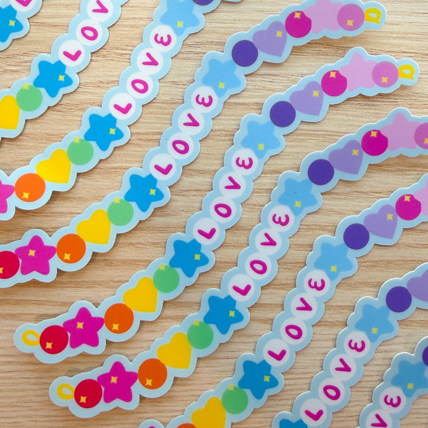 Decorative stickers with 'LOVE' and colorful designs on a wooden surface