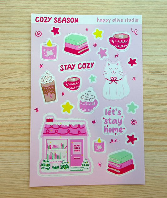 Sticker sheet with cute illustrations and text on a pink background, featuring the brand 'happy olive studios'.